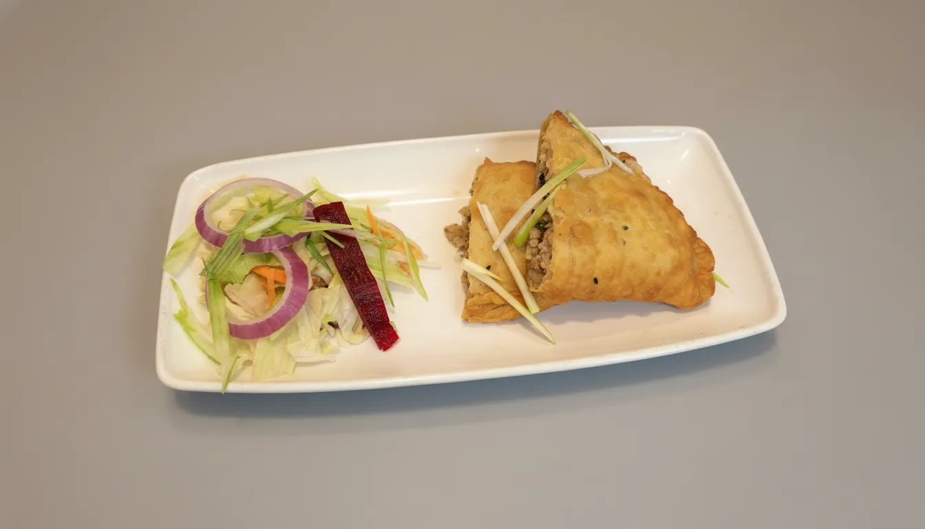 Nepalese shyabale fried dumplings served with chilli sauce.