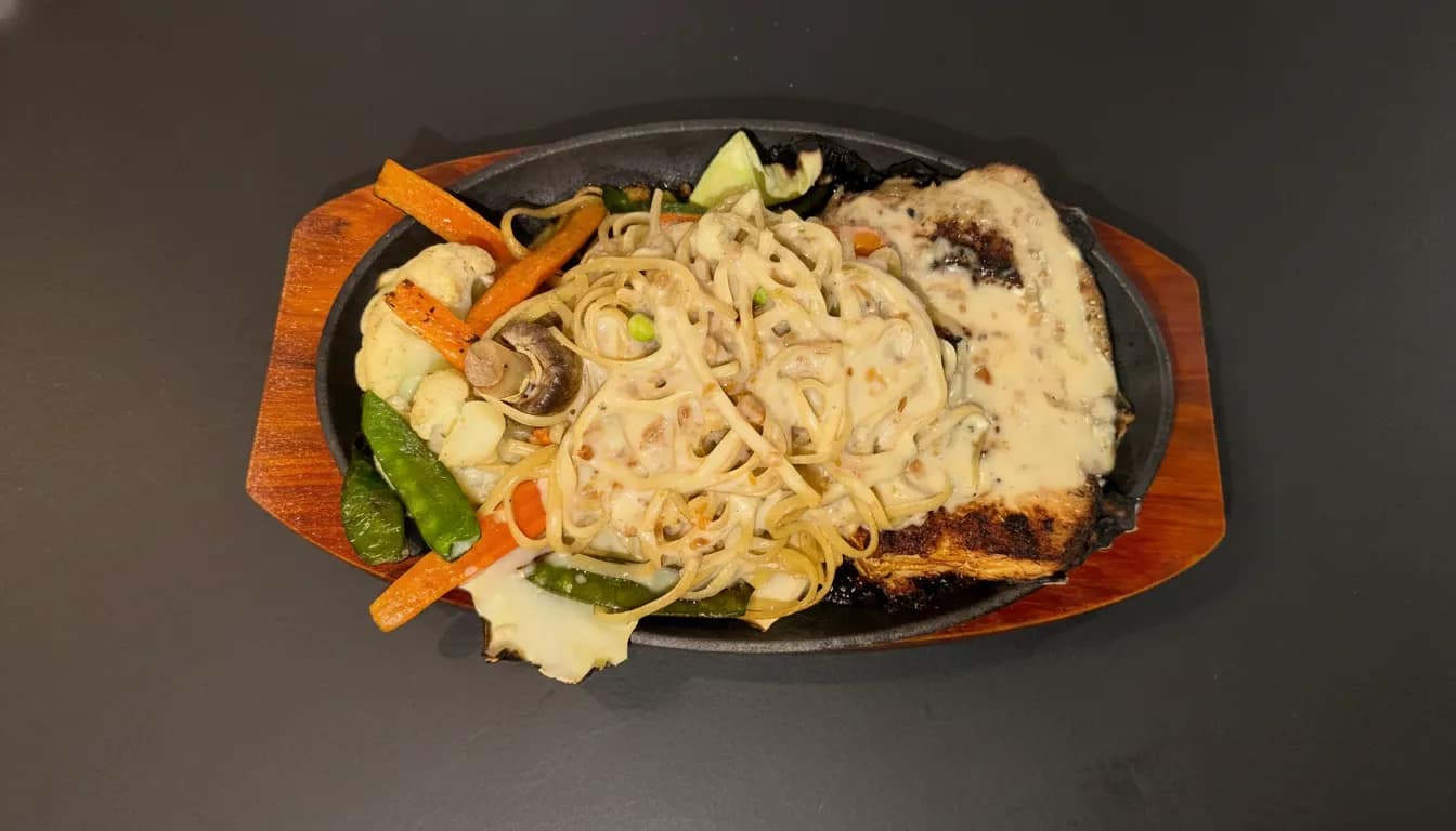 Sizzler pasta with roasted vegetables and rich tomato sauce.