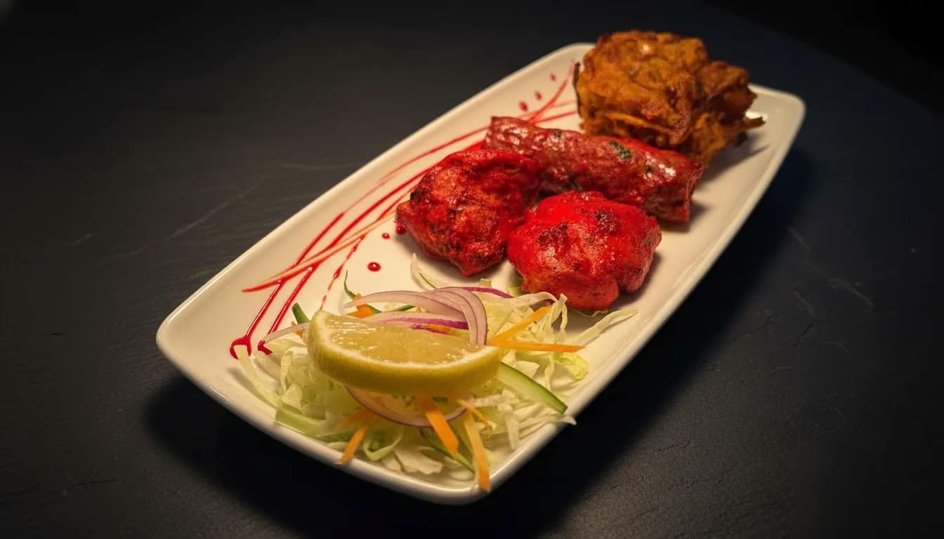 Tandoori appetiser platter with grilled meats and salad.