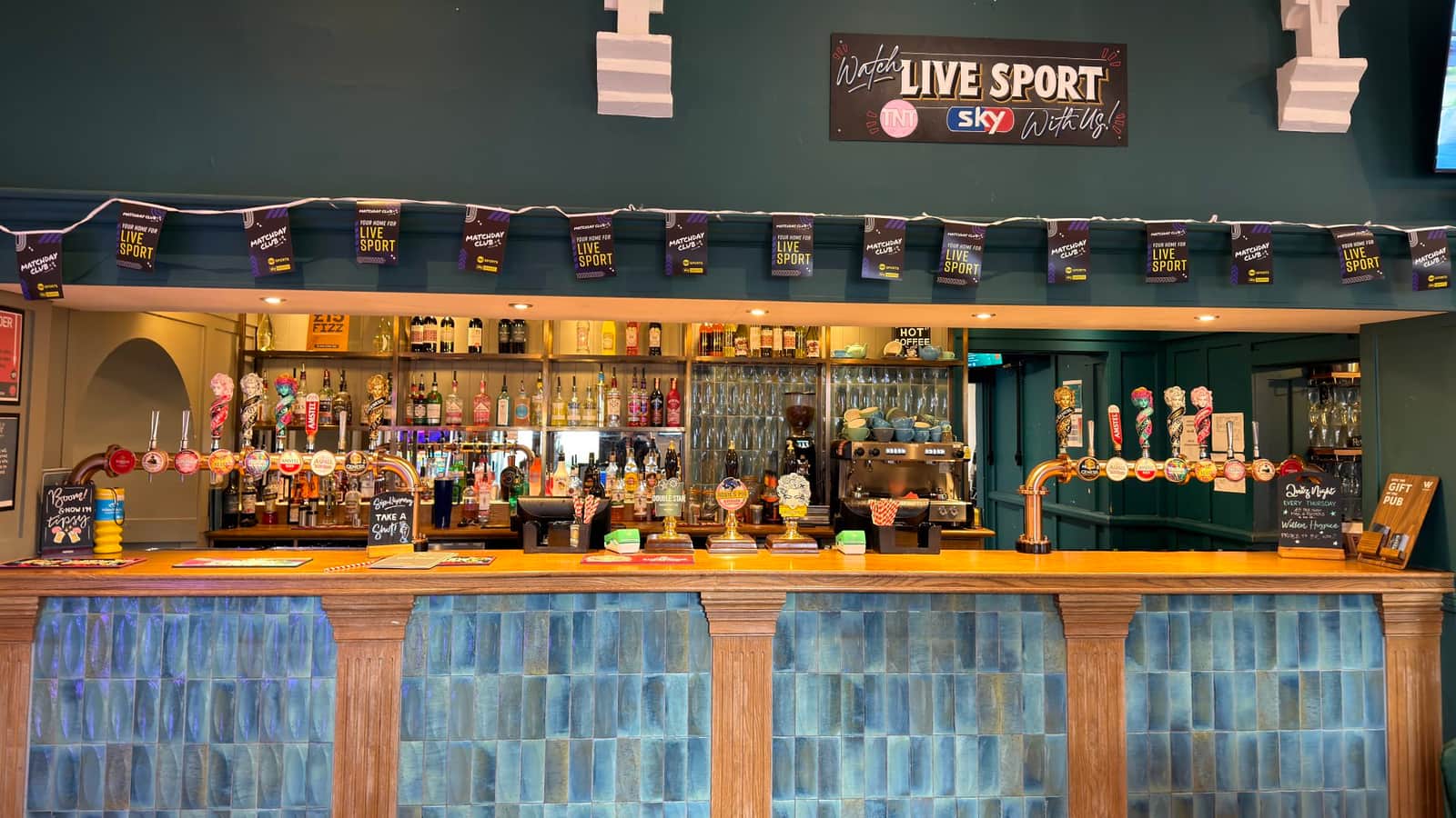 Fresh pints being poured at the bar inside The Old School House.