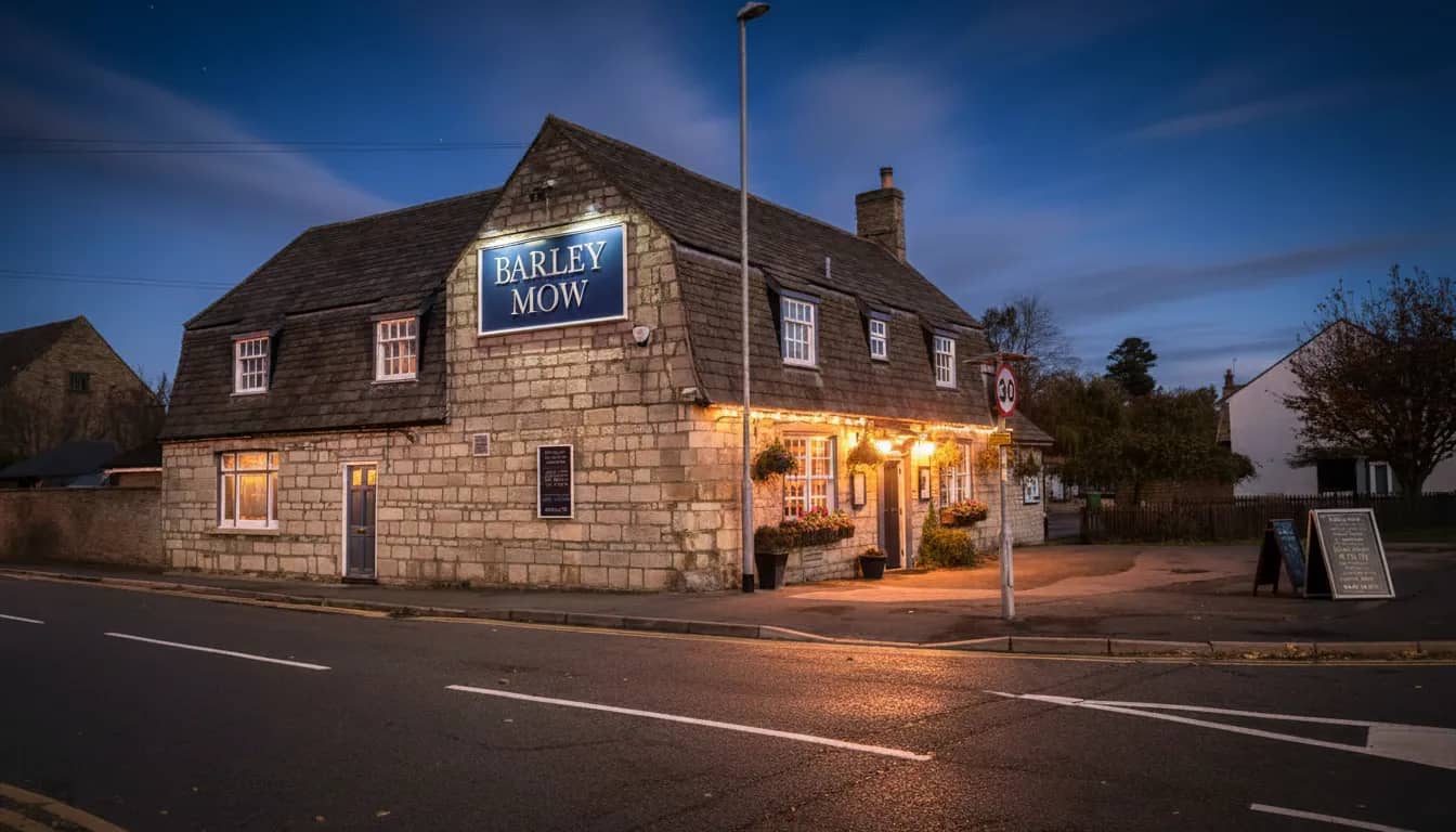 Barley Mow historic inn exterior with signage, hanging baskets, and entrance patio.