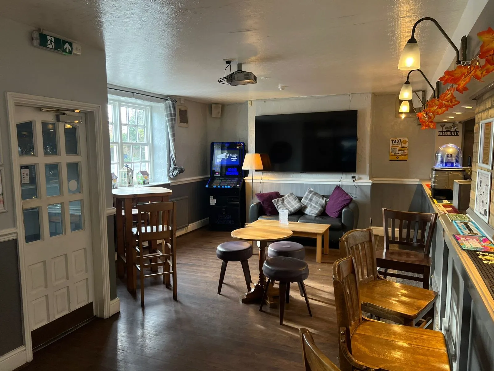 Bar lounge interior with log fire and sofas.