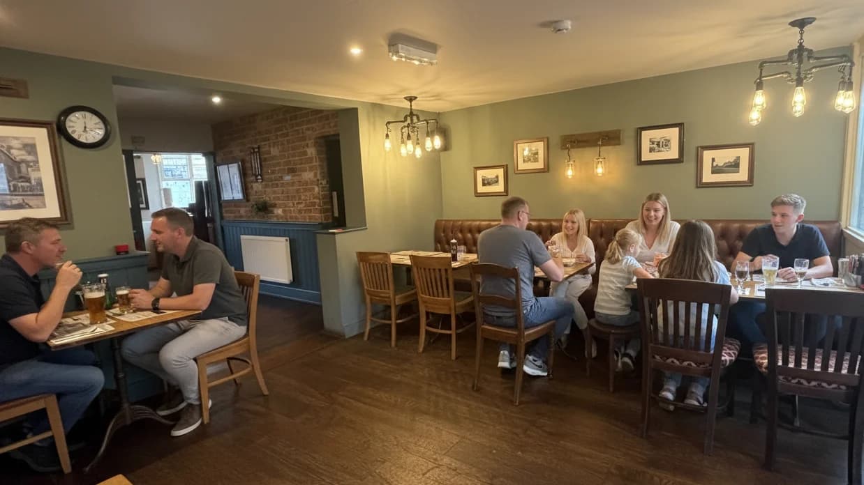 Dining room with banquette seating and framed art.