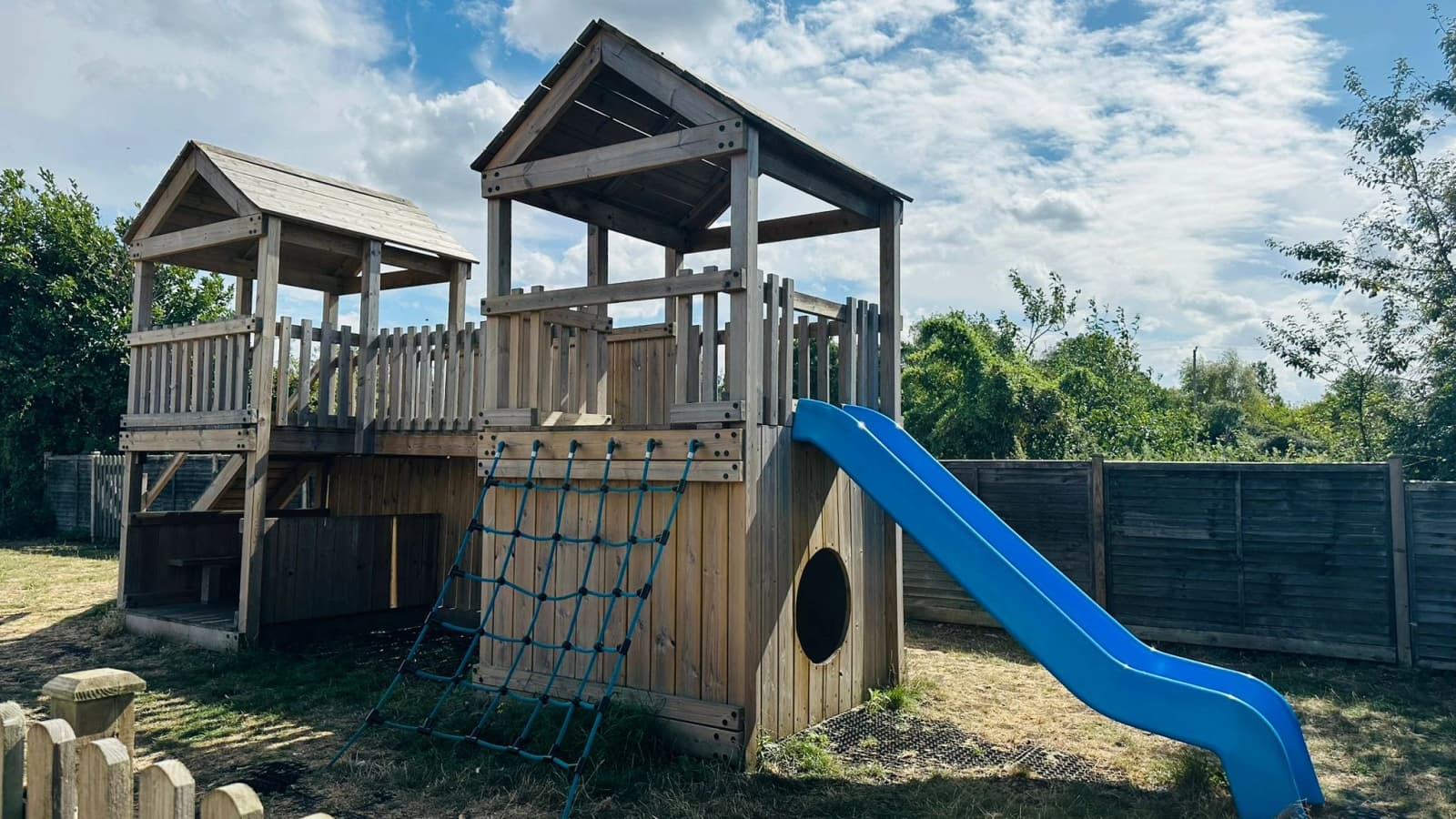Children's wooden play area beside The Old Crown beer garden.