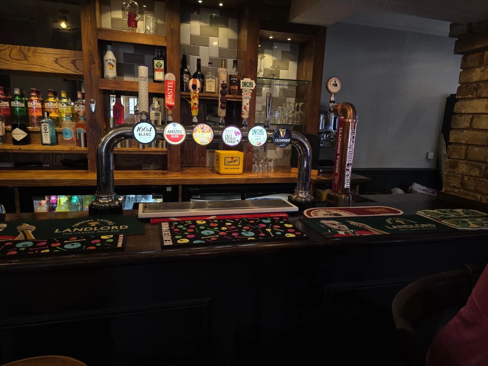 White Horse bar with cask pumps, spirits shelves, and warm lighting.